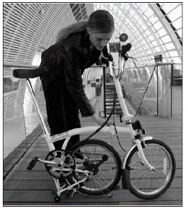 Modern folding bike being folded up to travel as airline luggage.