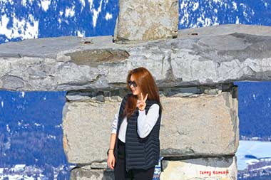 Whistler-Blackcomb woman posing at Inukshuk