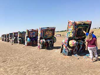 Spray painting the rear end of Cadillacs in Amarillo, Texas