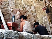 Lourdes Navarrete with co-workers doing conservation work at Kohunlich and these same two masks in 2006